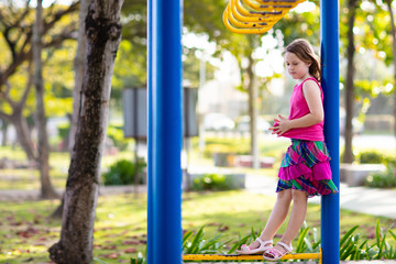 Child on playground. Kids play outdoor.