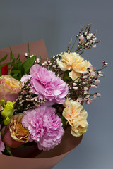 Detail closeup of beautiful bridal bouquet in retro style, light gray background, selective focus
