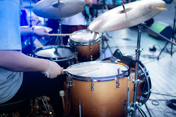 Fototapeta na wymiar Selective focus Drummer playing on drum set on stage. Musician plays a musical instrument on the concert stage