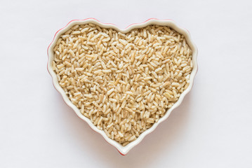 Uncooked Brown Rice in a Heart Shaped Bowl