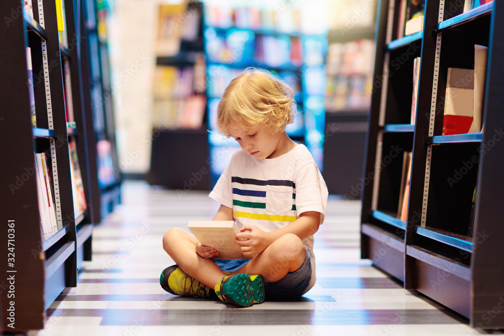 Poster Child in school library. Kids reading books.