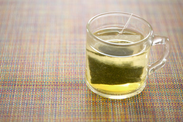green tea in glass cup on table