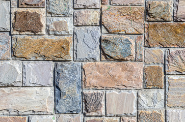 Wall of colored artificial stone as a background.