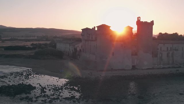 Santa Severa Beach and Castle at sunrise, Province of Rome, Italy. Aerial drone view