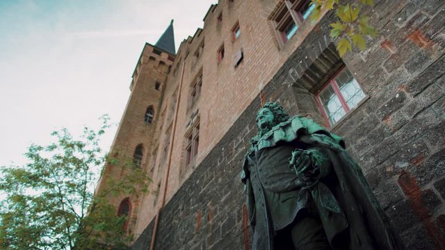 Castle with statue at the front in daylight