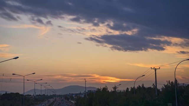 Time lapse of Greek National Highway E75, taken from Varympompi intersection bridge during sunset, on a cloudy day