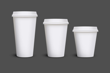 White blank takeaway paper, carton or cardboard coffee cup in different size on isolated white background, including clipping path for cutout. Empty tea mockup for presentation on isolated background.