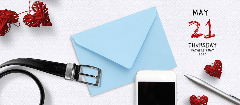 envelope and smartphone on paper background with reminder for father's day 2020