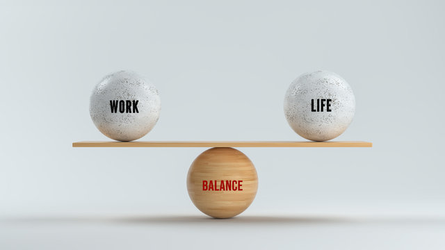 wooden balls forming a scale for WORK, LIFE and BALANCE on white background