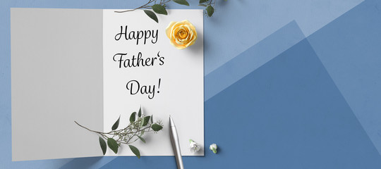 card with text HAPPY FATHER'S DAY and a flower on paper background