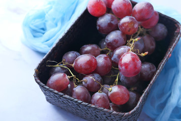Close up of red grape in a container on table 