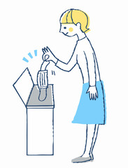 使用済みマスクをゴミ箱に入れる女性