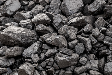 Coal anthracite in the autumn in a heap close-up as a background outdoors