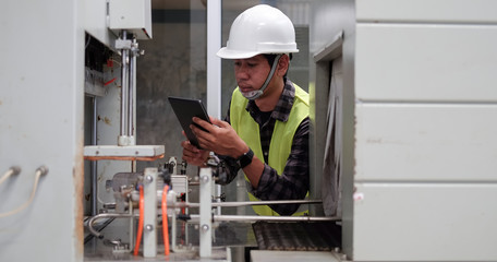 Cropped shot view Manager Technical Industrial Engineer working and control robotics with monitoring system software and industry network connection on tablet.