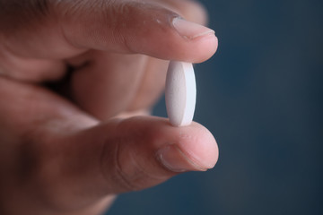 close up of pills or capsule in man hand 