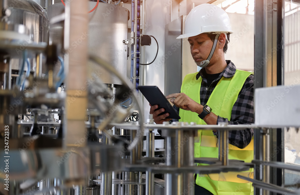 Wall mural cropped shot view manager technical industrial engineer working and control robotics with monitoring