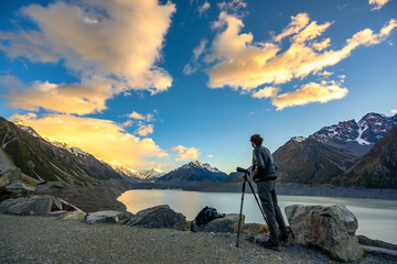 Photographers are shooting at Tasman Lake, the morning skies and beautiful clouds in Mount Cook National Park, Aoraki, New Zealand.