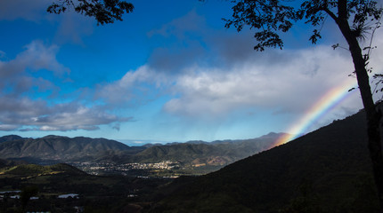 dramatic rainbow in caribbean mountains over San Jose De Ocoa, Dominican Republic,