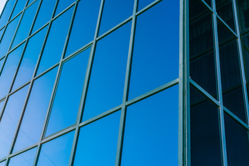 modern glass building. blue glass and concrete building for offices and businesses