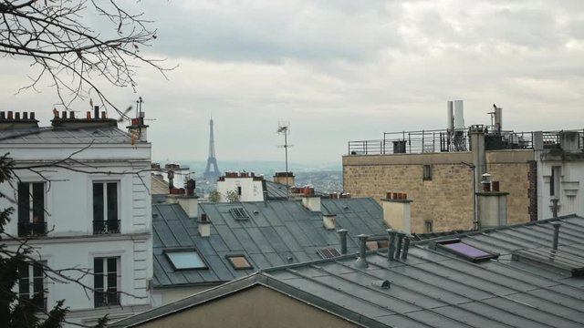 View of city roofs and the Tour Eiffel from the Réservoir de Montmartre on a rainy autumn day