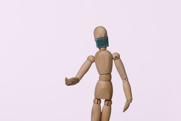 wooden figure wearing face mask