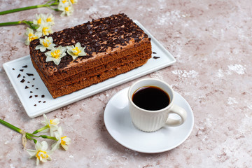 Tasty homemade chocolate truffle cake with coffee on light background