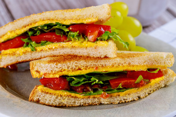 Grilled cheese sandwich with vegetable and grape.