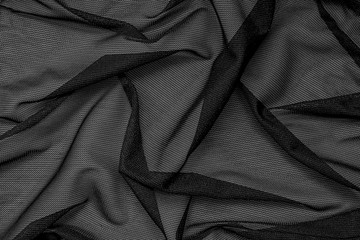 Black mesh fabric as background.