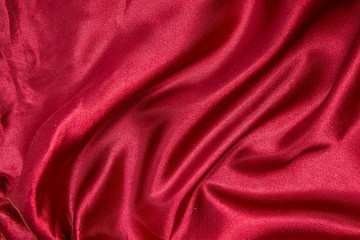 Fototapeta na wymiar Red shiny fabric as a background.