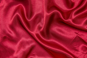 Red shiny fabric as a background.