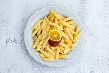 Cooked prepared Italian macaroni pasta tubes shaped on plate. Vegan vegetarian diet food