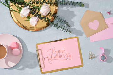 flat lay composition with flowers, a cup o coffee and sweets. Concept valentines day top view