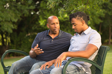 Mature man mentoring and giving advice to a younger man.