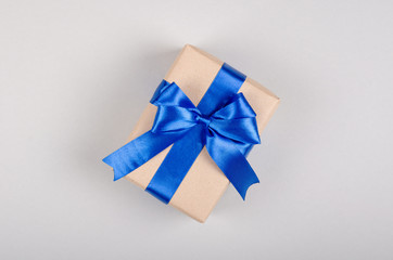 Gift box on gray background composition, present with ribbon and bow.