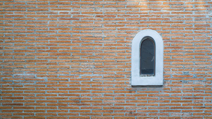 Small windows on the brick house walls