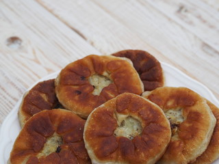 Belyasha homemade baking with meat on a white rustic wooden table.