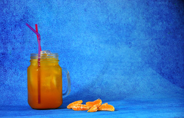 Glass mug with citrus juice, ice and slices of mandarna next. Close up shot. © Алексей Желтухин