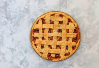 Homemade apple pie on grey concrete background,top view