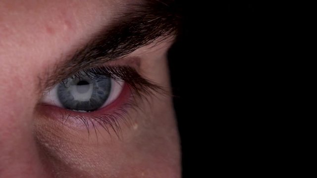 Close Up Of Right Male Eye With Reflection Of Computer Screen On Eyeball. Locked Off