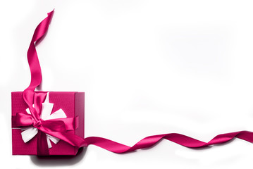 Pink gift box with bow and ribbon on a white background, isolated image