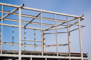 metal construction of a building under construction against the sky