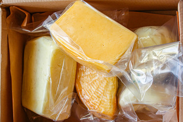 cheese shopping, many different types of pieces slices packaged (cheese product) menu concept...