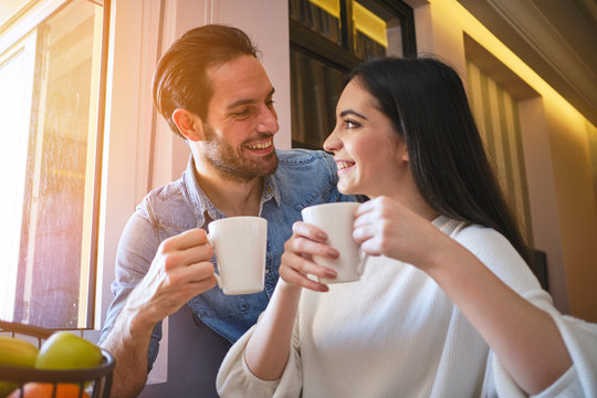 Beauty caucasian couple having nice moments at home enjoying in hugs, coffee and time together