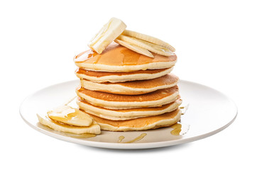 Tasty pancakes with honey, butter and banana on white background