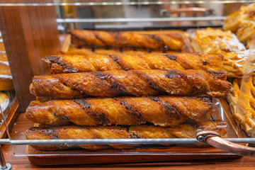 Crusty baked egg rolls for sale at pastry shop 
