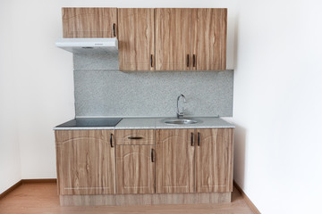 Obraz premium New standard wood kitchen furniture against white walls