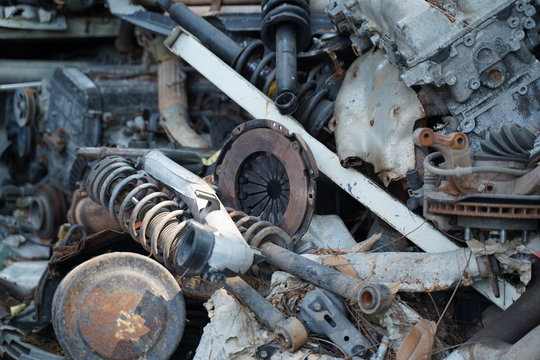 Junk yard full of car's part , engine , body.