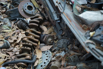 Junk yard full of car's part , engine , body.