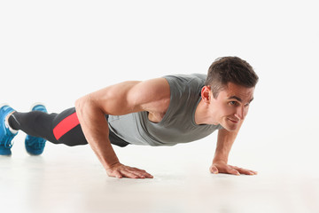 Fitness man wringing from the floor demonstrates good physical exercises isolated on white background healthy lifestyle for many people exercising their own weight for losing for every day push up.