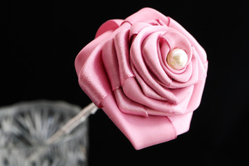 Picture of an artificial flower. Flower of satin ribbon. Handmade.